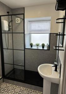 a bathroom with a shower and a sink at Middlecroft in Chesterfield