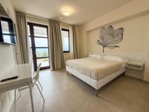 a bedroom with a bed with a flower on the wall at Hurz in Pietrelcina +43 photos