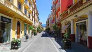 an empty street in a city with buildings at Agora Apartments -Friend's House Sorrento in Sorrento