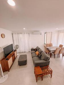 a living room with a couch and a television at Enzos Haven - Tagaytay in Tagaytay