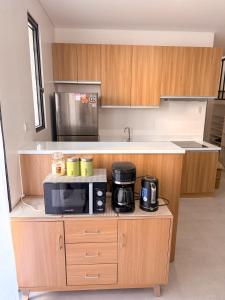 a kitchen with a microwave and appliances on a counter at Enzos Haven - Tagaytay in Tagaytay