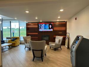 a waiting room with chairs and a flat screen tv at Comfort Inn in Princeton