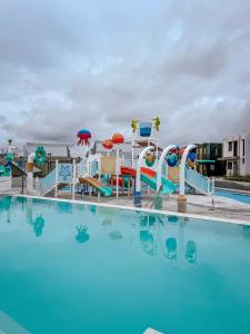a pool with a water park with a water slide at Enzos Haven - Tagaytay in Tagaytay