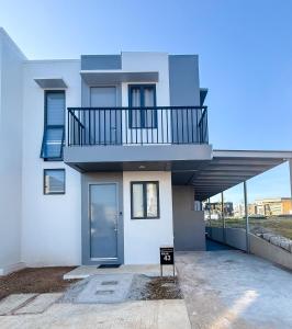 a large white house with a balcony on it at Enzos Haven - Tagaytay in Tagaytay