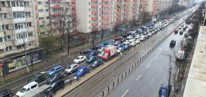 a long line of cars parked on a city street at 5th Floor Oasis 2 Badroom Apartment in Bucharest