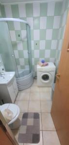 a bathroom with a toilet a sink and a shower at 5th Floor Oasis 2 Badroom Apartment in Bucharest +14 photos