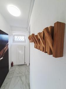 a hallway with a white wall with wooden shelves at Casa D'oro1700 - Old town Koper in Koper