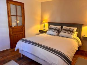 a bedroom with a large white bed with two pillows at La Bastide des Dentelles in Roaix +49 photos