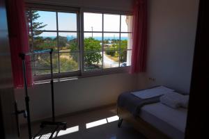 a bedroom with a bed and a window with a view at Sea Breeze Alexandroupolis in Alexandroupoli