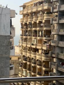 a large building with balconies on the side of it at Light Tower in Alexandria
