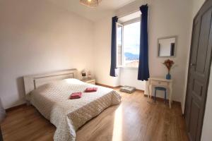 a bedroom with a bed and a window at Spacious cocoon close to the beach in Ajaccio