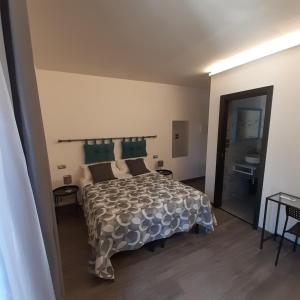 a bedroom with a large bed and a bathroom at Angela's house in Sulmona