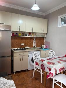 a kitchen with a table and a table and a table and a kitchen with at bubu in Kobuleti