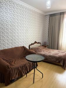 a bedroom with two beds and a table in it at bubu in Kobuleti