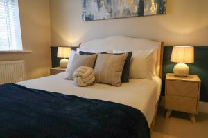 a bedroom with a bed with a towel on it at Windsor Cottage in Holmfirth +36 photos