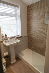 a bathroom with a sink and a shower at Windsor Cottage in Holmfirth