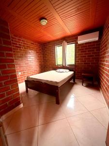 a room with a bed in a brick wall at El Faro de los Abuelos in San Bernardo del Viento +7 photos
