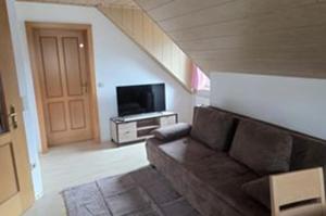 a living room with a couch and a flat screen tv at Henrik's Ferienwohnung in Öblarn