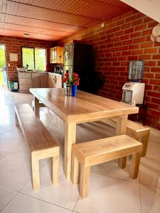 a wooden table and benches in a kitchen at El Faro de los Abuelos in San Bernardo del Viento