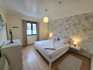 a bedroom with a bed and a wall with writing on it at Quinta Velha in Ribeira Grande +37 photos