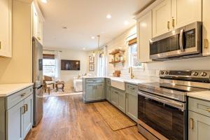 a kitchen with stainless steel appliances and a living room at Kildahl House - Boutique Farmhouse Suite #1 in West Dundee