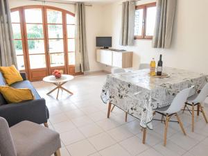 a living room with a table and a couch at Apartment Le Platane by Interhome in Velleron
