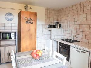 a kitchen with a table with a bowl of fruit on it at Apartment Le Platane by Interhome in Velleron +18 photos