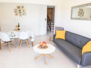 a living room with a couch and a table at Apartment Le Platane by Interhome in Velleron