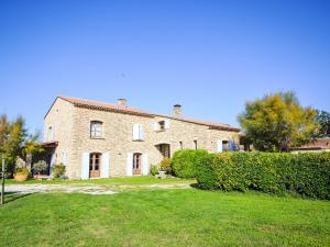 a large brick house with a green yard at Apartment Le Platane by Interhome in Velleron