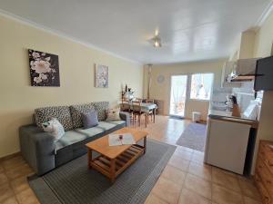 a living room with a couch and a table at Quinta Velha in Ribeira Grande