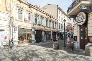 an empty street in an old town with buildings at RHUM B07 - Old Town Courtyard in Bucharest