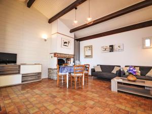 a living room with a couch and a table at Holiday Home Le Real by Interhome in Velleron