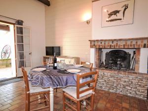 a dining room with a table and a fireplace at Holiday Home Le Real by Interhome in Velleron