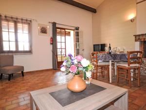 a vase with flowers on a table in a living room at Holiday Home Le Real by Interhome in Velleron +20 photos