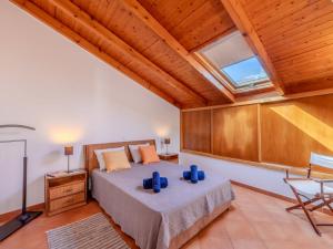 a bedroom with a bed and a skylight at Holiday Home Rua 5 de Outubro by Interhome in Lagos