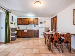 a kitchen with a table and chairs in a room at Apartment Grand Sarriod-5 by Interhome in Saint Nicolas +12 photos