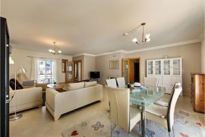 a living room with a couch and a table at Casa Brisa Tavira in Tavira