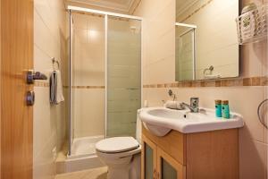 a bathroom with a toilet and a sink and a shower at Casa Brisa Tavira in Tavira +27 photos