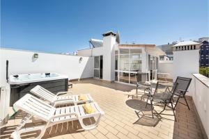 a patio with chairs and tables on a roof at Casa Brisa Tavira in Tavira