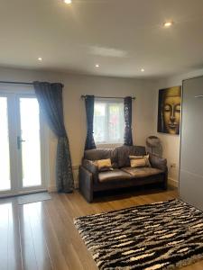 a living room with a couch and a window at Family cottage in Epsom