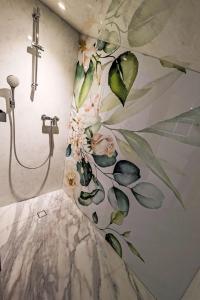a bathroom with a flower mural on the wall at Apartment LiloTopMountainView by Interhome in Beatenberg