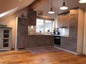 a kitchen with stainless steel appliances and a window at FeWoSchwedenhaus in Gleiszellen-Gleishorbach +12 photos