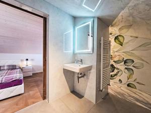 a bathroom with a sink next to a bed at Apartment LiloTopMountainView by Interhome in Beatenberg