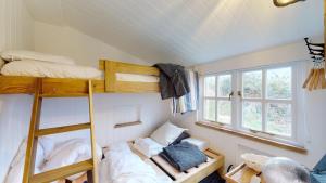 a room with two bunk beds and a window at F12 West View, Riviere Towans in Hayle