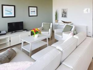 a white living room with a white couch and chairs at Apartment Albatros with parking by Interhome in Bredene