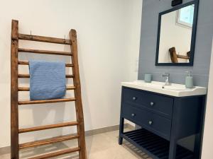 a bathroom with a sink and a ladder next to a mirror at Moulin de Bas Couleur in Villedômer +22 photos