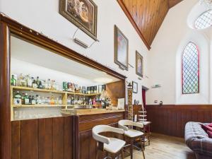 a bar in a church with stools at The Auld Kirk in Ballater