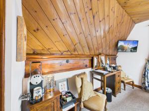 a room with a desk and a wooden ceiling at The Auld Kirk in Ballater