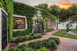 a ivy covered building with a black door at Heights Ironworks Bed & Breakfast in Houston