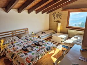 a bedroom with two beds and a window at Chalet Chalet Aglaia by Interhome in Crans-Montana